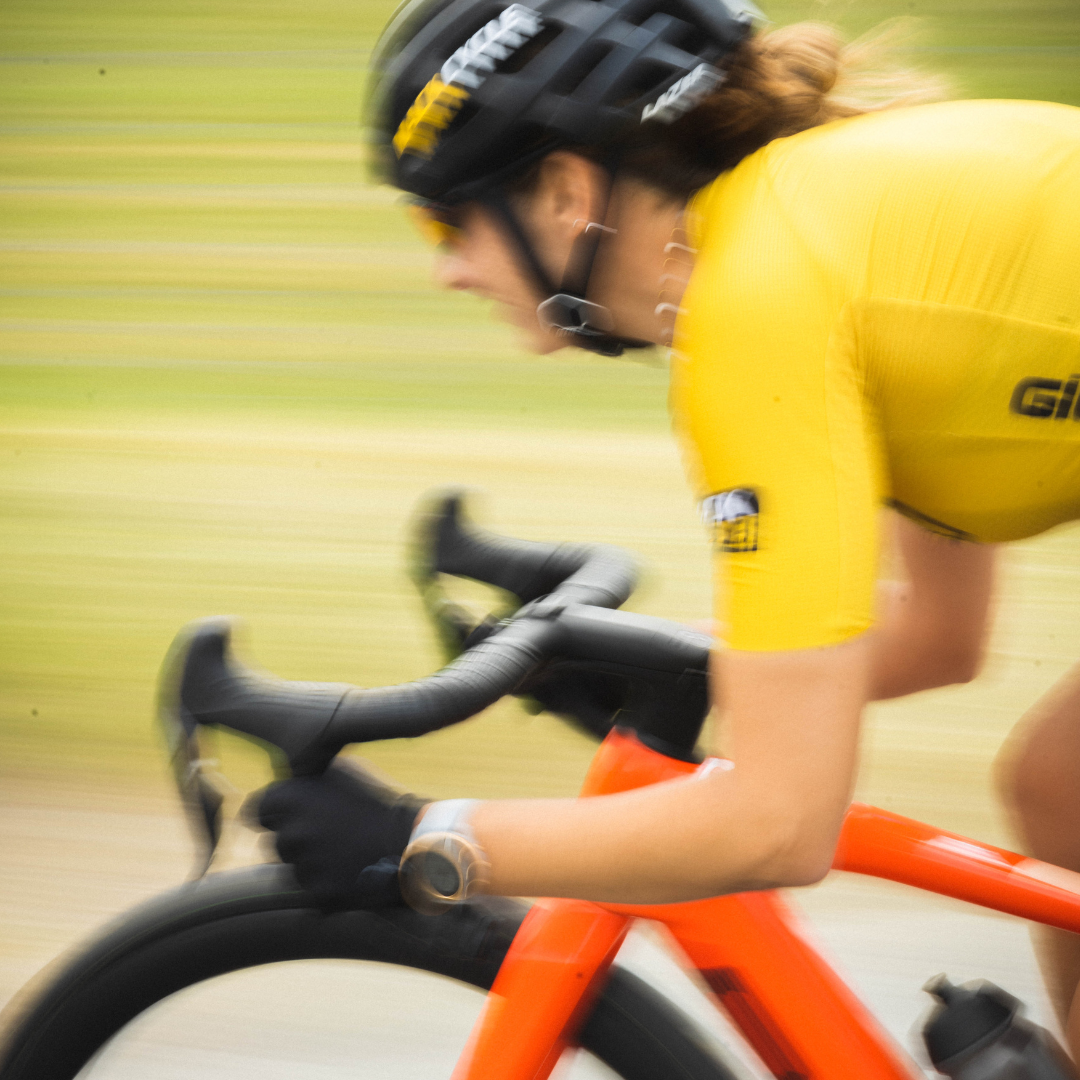 RACHEL FROM MACK CYCLE RIDING A BMC AMP ROAD-E BIKE IN SWITZERLAND IN HER GOLD GIORDANA MACK CYCLE CUSTOM JERSEY