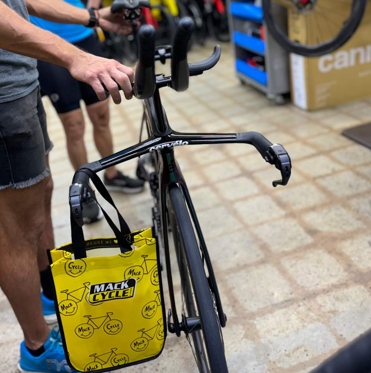 The front end cockpit of the Cervelo P5 SRAM Force eTap AXS Bike in Twighlight Chameleon. The bike is inside the mack cycle service department ready to fly. 