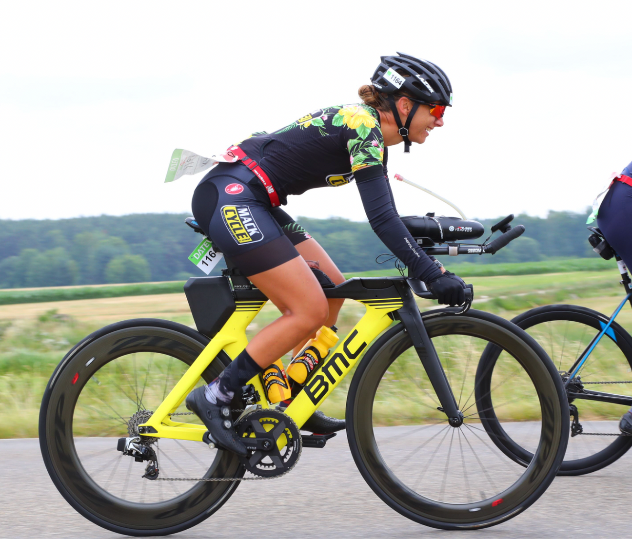 Girl wearing floral Castelli Mack Cycle Tri Suit at Challenge Roth in Germany. She is riding a Yelllow BMC Time Machine Triathlon Bike. 